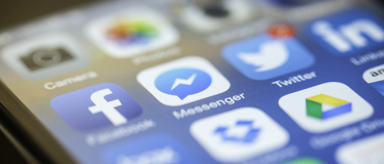 Conversational Business. A smartphone displays social media icons.