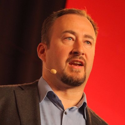 A photograph of Alistair Croll presenting.