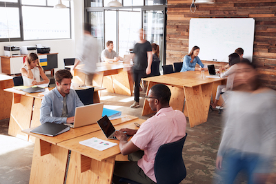 People in an open office seated at desks.