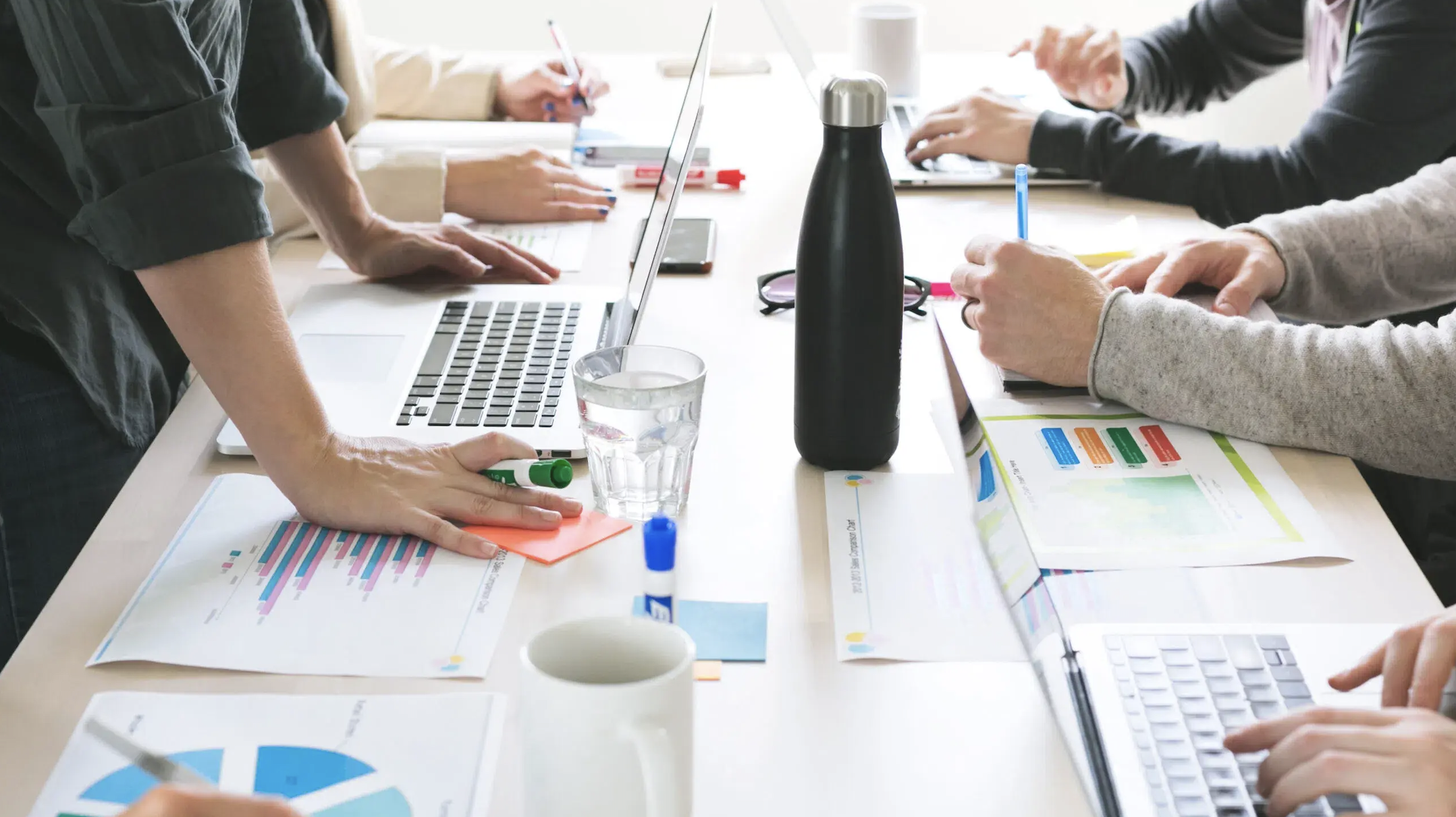 hands-on-desk-at-meeting-scaled